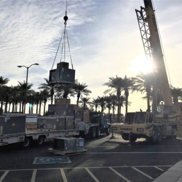 Multiple package rooftop units being craned into place in Sun City Grand